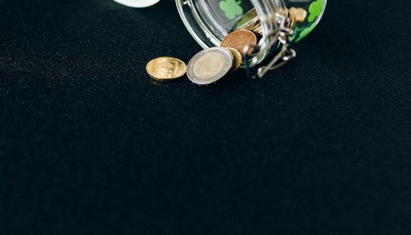 Coins and a jar representing saving money