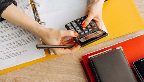 Calculator and bills on a desk